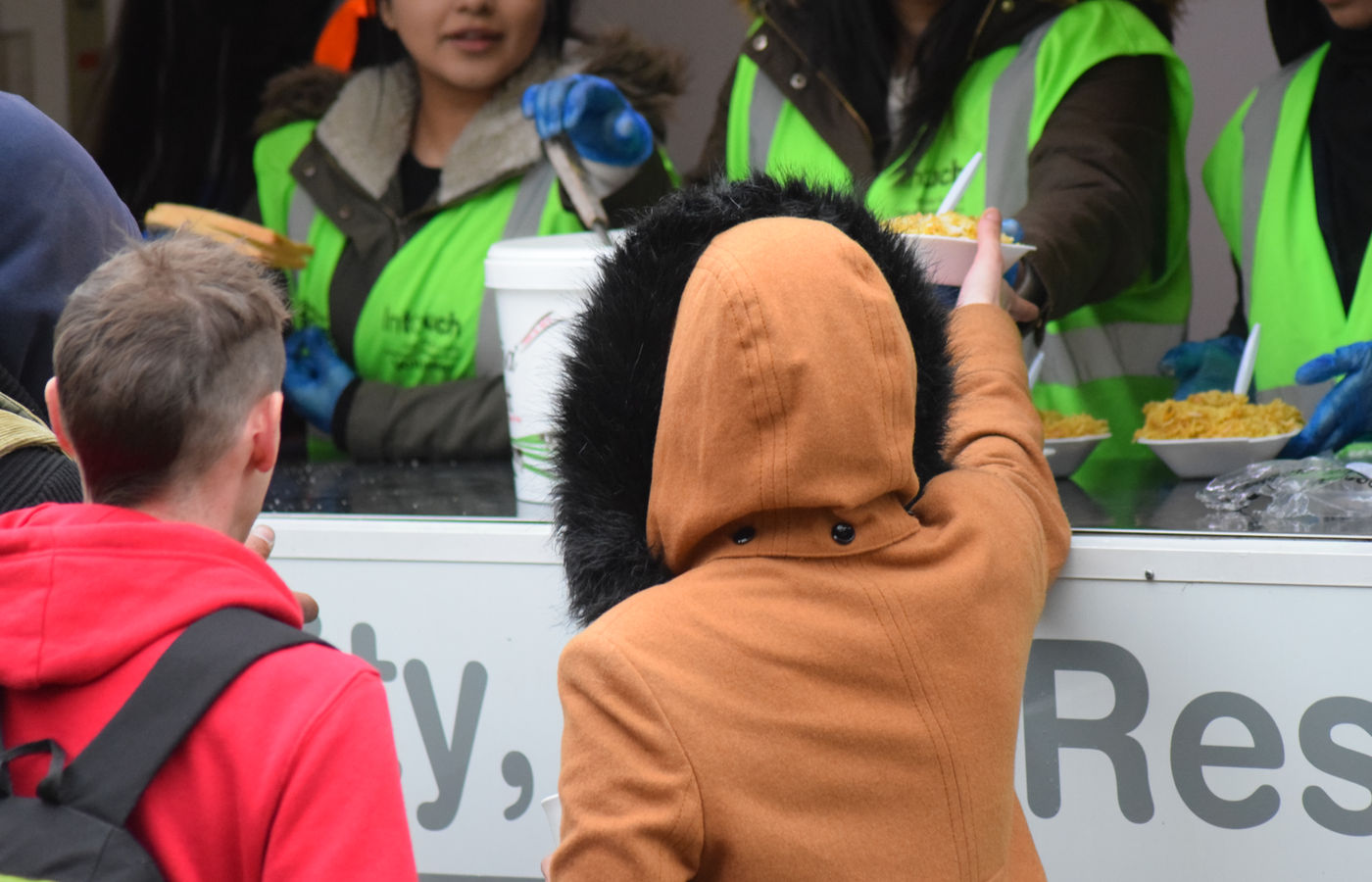 Volunteers serving hot meals at an InTouch Foundation session